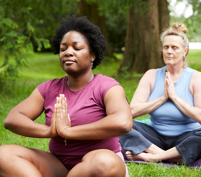 women doing yoga outside