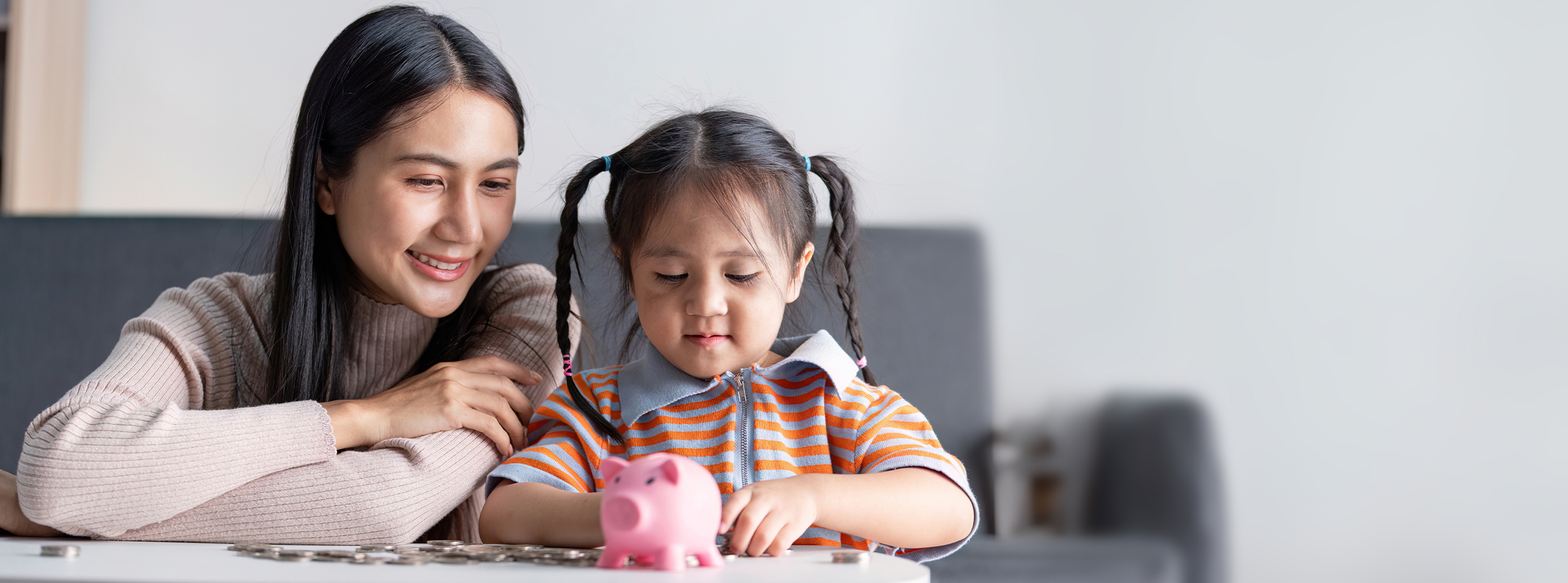 mom and daughter counting coins