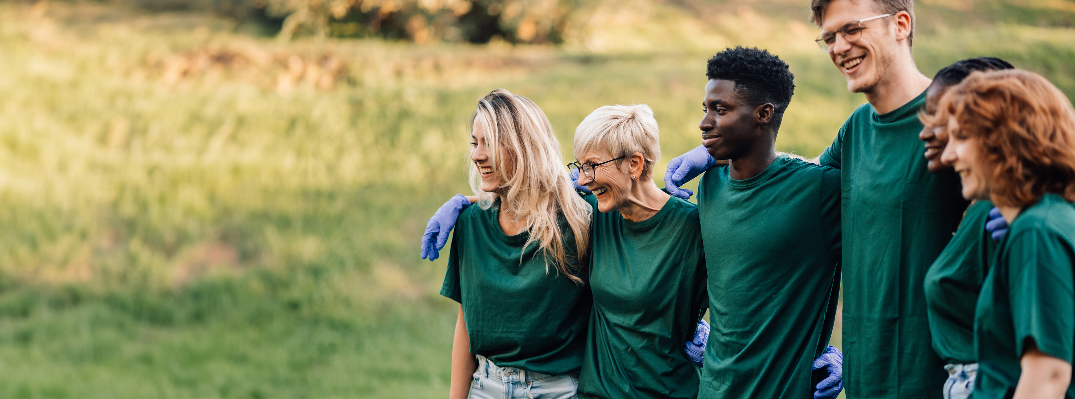 group of volunteers in green t shirts