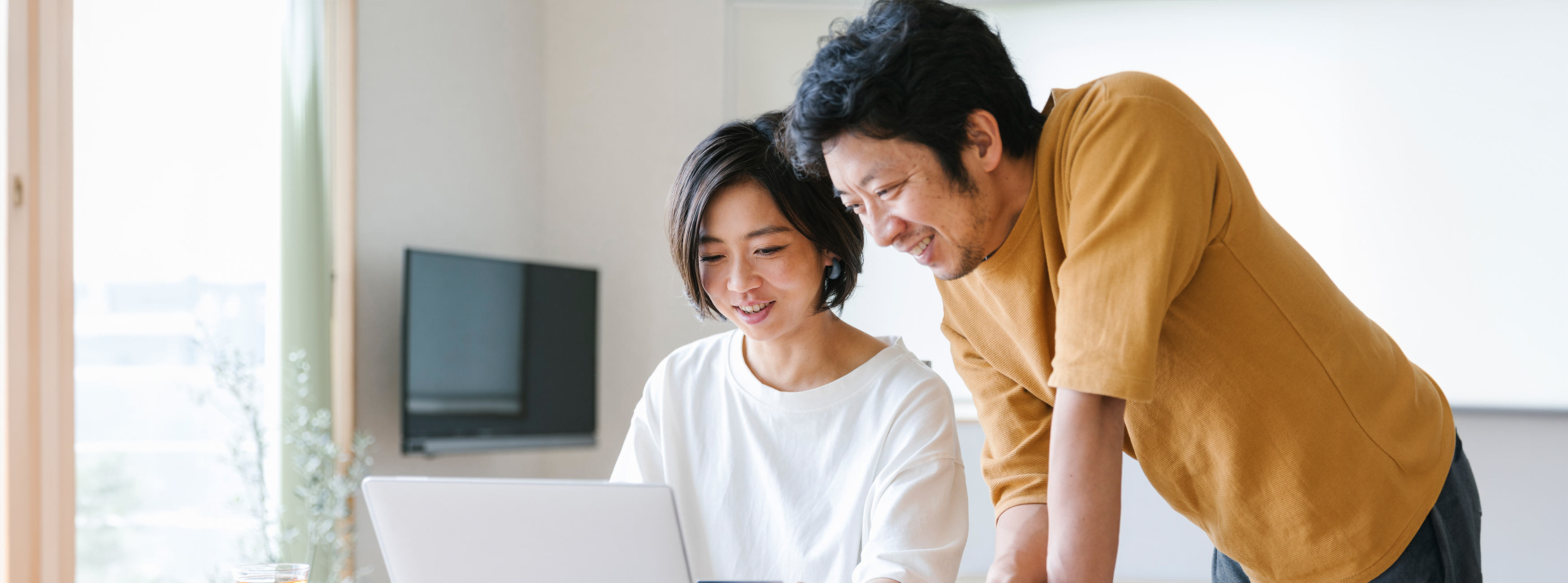 two people looking at a computer together